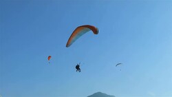 Paraglider Landing at Hï¿½hematte Park, Interlake, Switzerland Stock Footage