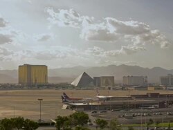 T/L, HA, WS, Passenger jets on tarmac, The Strip buildings in background, Las Vegas, Nevada, USA Stock Footage