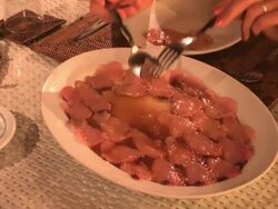 Hands serving some tuna carpaccio, close up, restaurant golden lights Stock Footage