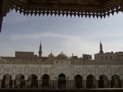 High Angle, push-in tilt-down - Muslims cross a courtyard and enter a mosque / Egypt Stock Footage