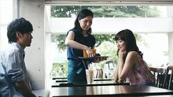 Waitress serves asian couple in cafe Stock Footage