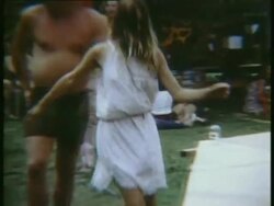 1969 MONTAGE MS PAN ZI ZO Woman in white dress spinning around and dancing to music beside stage at Woodstock music festival/Bethel, New York, USA Stock Footage
