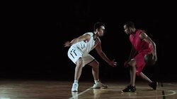 SLO MO of red basketball player dribbling the opponent Stock Footage