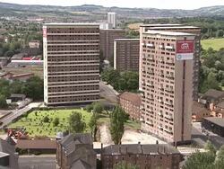 WS Two tall apartment buildings are demolished in controlled implosions using explosives and dissappear in huge cloud of dust / Pollokshaws, scotland, UK Stock Footage