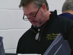 CU ZO Shot of male voter casts ballot at copmuter terminal during voting in presidential election / Sylvania, Ohio, United States  Stock Footage