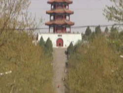 Long Shot Wide Shot Zoom Out - A chinese pagoda temple at the end of a long city street / China Stock Footage