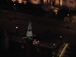 Aerial view of Nelson's Column/ zoom out to Trafalgar Square at night / London, England Stock Footage