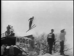 B/W 1962 PAN skier jumping in competition / Chamonix, France / newsreel Stock Footage