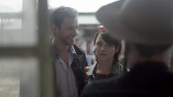 Friends chat with Texan shop vendor at outdoor market Stock Footage