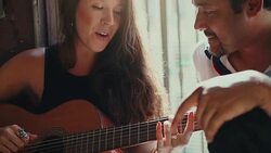 She plays guitar and sing for him Stock Footage