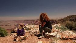 Mother talks to her young daughter on the rim of the Grand Canyon Stock Footage