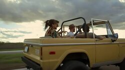Group of friends on road trip talk and laugh in classic Ford Bronco Stock Footage