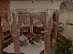 MS CS ZO Musicians playing sitar and tabla drums in  stone cuppola over Ganges river / India Stock Footage