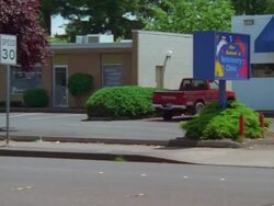 PAN View to small modern Veterinary Clinic animal hospital with blue roof and blue doors /Portland, Oregon, USA Stock Footage