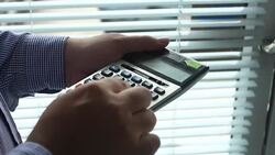 Businessman analyzing data on calculator Stock Footage