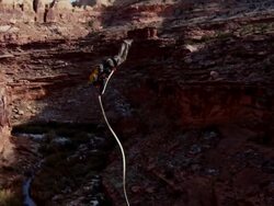 WS TD PAN SLO MO Man does  back flip off cliff in desert / Moab, Utah, United States   Stock Footage