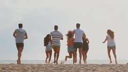 Summer in here: friends run together on the beach Stock Footage