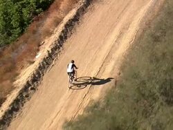 Aerial TS ZI of mountain bike cyclist / Topanga State Canyon, California, United States Stock Footage