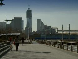 People walk and exercise at the Hudson River Park on the West Side of Manhattan Stock Footage