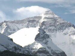 Long Shot static _ Clouds cast shadows as they drift over the summit of Mount Everest / Mount Everest, Tibet Stock Footage