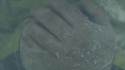 Snow falls on the clasped hands of a cold outdoorsman in Patagonia. Stock Footage