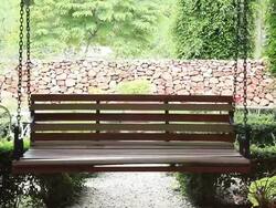 Wooden Swing swinging in tropical garden Stock Footage