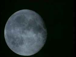 CU Full moon rising against black sky Stock Footage