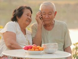 Happy senior couple talking on a mobile phone Stock Footage