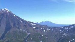 Snow caps are seen on the tops of volcanoes on the Kamchatka Peninsula. Stock Footage