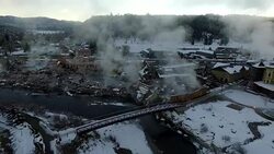 Aerial View of Winter Wonderland Pagosa Springs Colorado Bridge over San Juan River Hot Springs Steam Lifting Winter Snow Covered Rocky Mountains Stock Footage