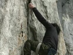 A japanese rock climber climbs up a limestone rock face Stock Footage