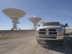  WS POV View of truck with trailer driving in Very Large Array in arid desert  / San Augustine, New Mexico, USA Stock Footage