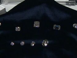 Several diamonds sparkle on a velvet cloth. Stock Footage