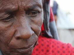 Refugee woman holding child eating bread Stock Footage