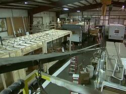 MS on man working on RV, pull out to reveal factory floor Stock Footage