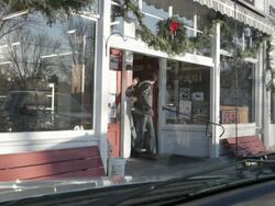 MS Two young men walking out of rural grocery store with beer and wood / Stillwater, Minnesota, United States Stock Footage