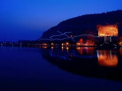 A view of the illumnated Sutra Caves in China from across a river at night. Stock Footage