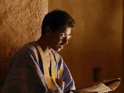 A man reading poetry in the library of Chinguetti Stock Footage