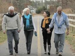 Mature friends walking on path Stock Footage