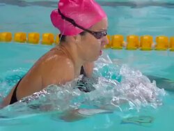 HD Super Slow-Mo: Young Woman Swimming Breaststroke Stock Footage