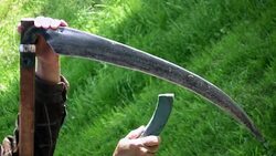 Sharpening the scythe Stock Footage