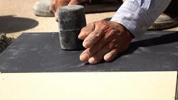 slow-motion, construction worker using hammer tiling floor Stock Footage