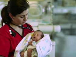 Female doctor holds a newborn baby Stock Footage