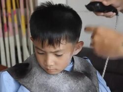 The Asian boy having a haircut. Stock Footage