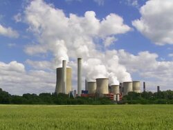 Steaming Coal Power Plant in Agricultural Landscape Stock Footage