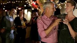 Happy couple celebrating at multi-ethnic backyard party Stock Footage