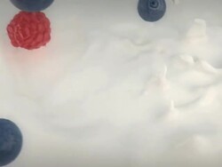 fruit falling into milk Stock Footage