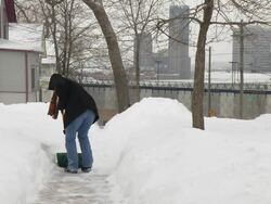 MS Woman in jeans shoveling snow from walkway / Saint Paul, Minnesota, United States  Stock Footage