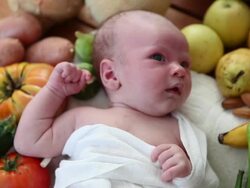 Newborn baby with fruits and vegetables Stock Footage