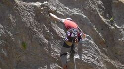 A young man rock climbing on a mountain.  - Slow Motion Stock Footage